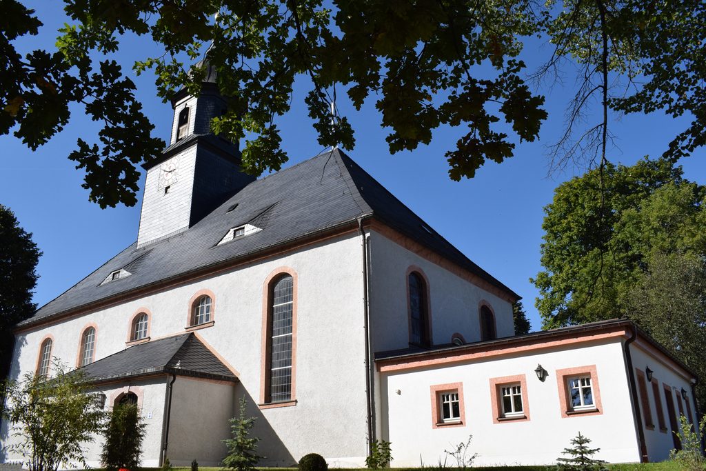 Kirche Weißbach mit blauem Himmel im Hintergrund